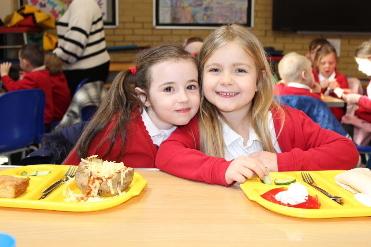 two girls eating a school lunch